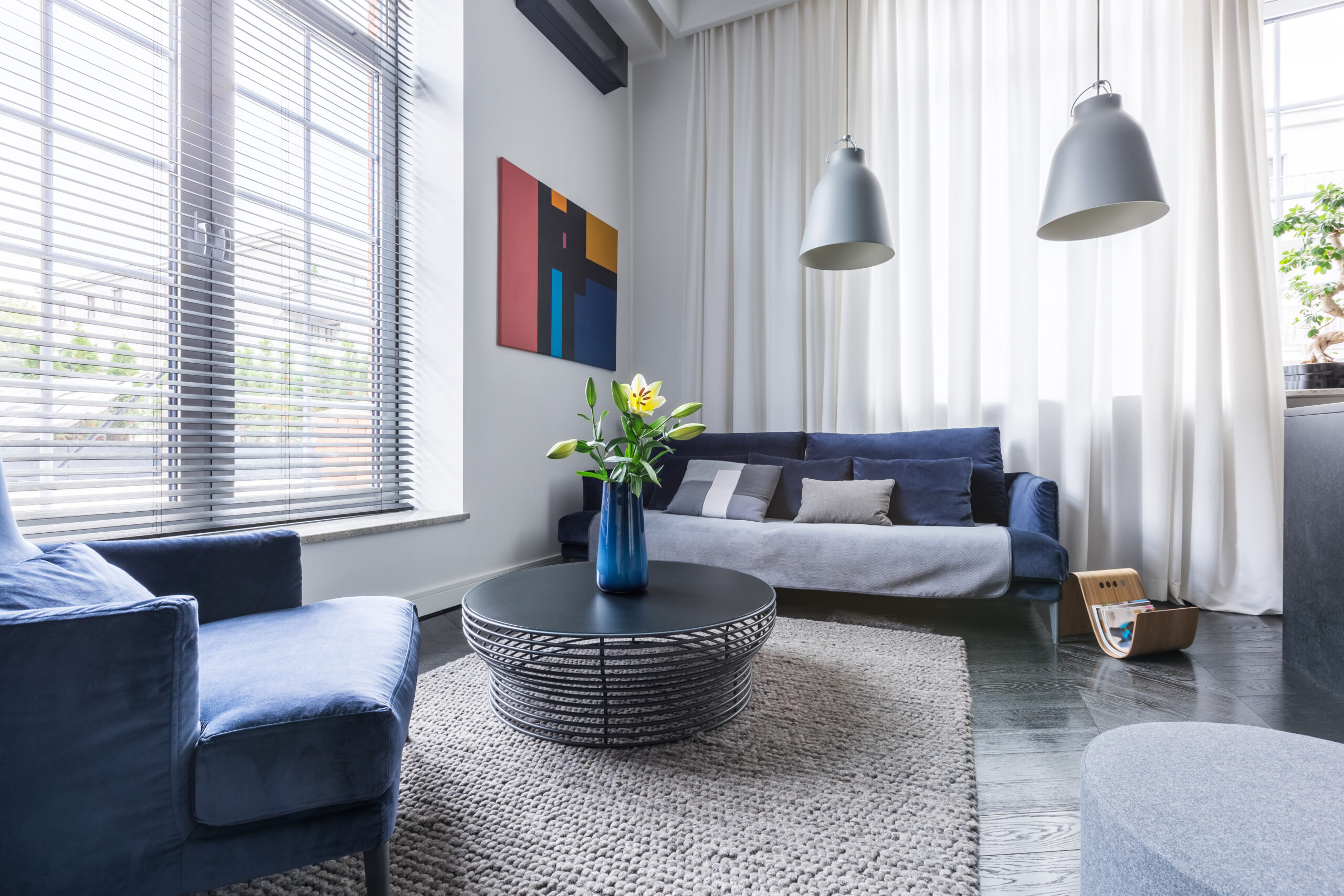 Living,Room,With,Blue,Upholstered,Furniture,,Window,Blinds,And,White